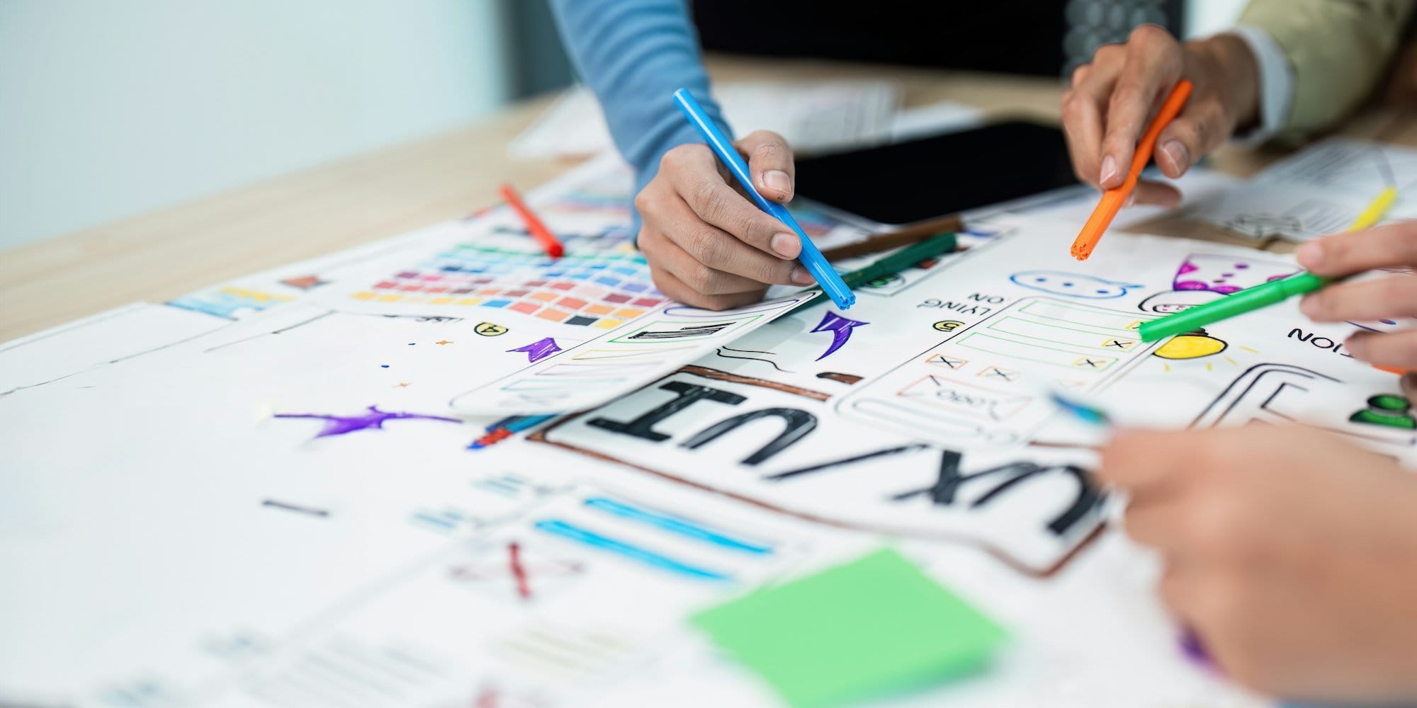 team of UI UX web designer are working together to develop mobile responsive websites with UI UX